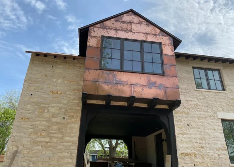 Copper metal panel facade on a stone building for Skylight Installation in Modesto